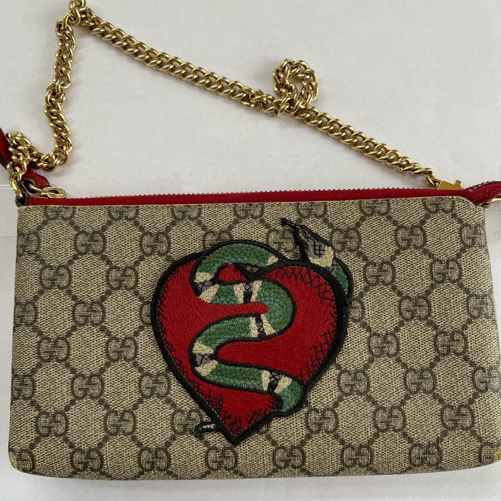 GUCCI limited edition 
GG Supreme Coated Canvas Snake Heart Shoulder Bag